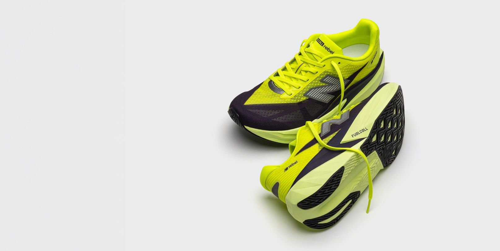 A pair of green and black FuelCell Rebel v5 shoes. 