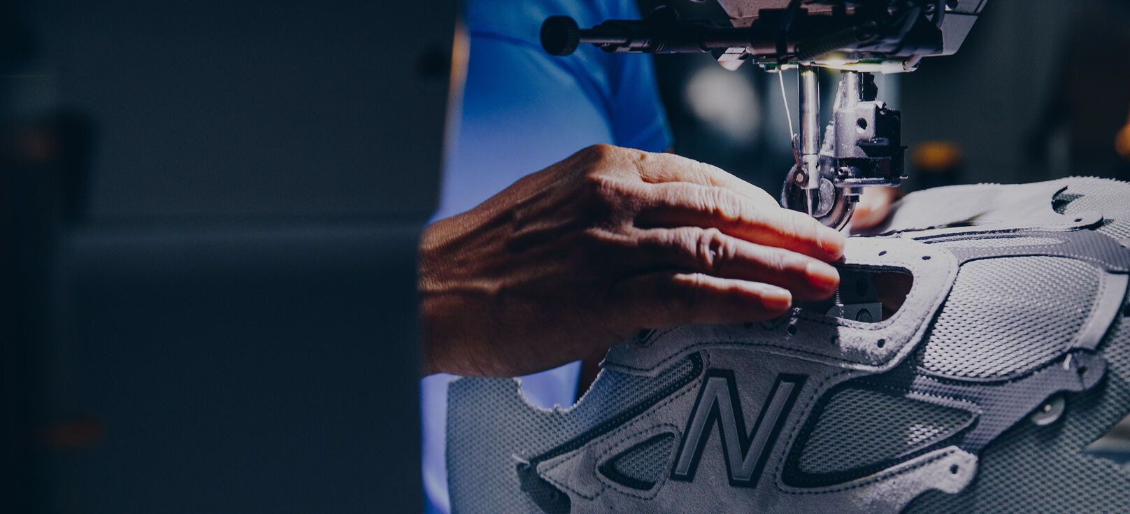 Person sewing shoe materials together