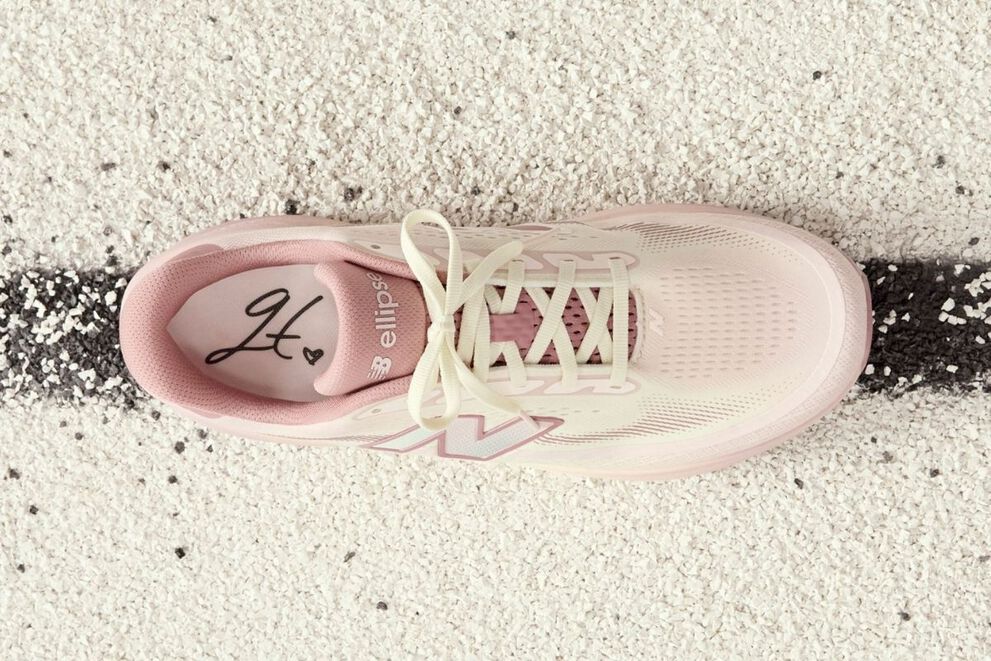One pink Ellipse shoe on a track. 
